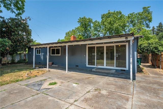 1577 Hawthorne Ave, Chico, CA 95926 - back of property with a patio area, a fenced backyard, and a chimney