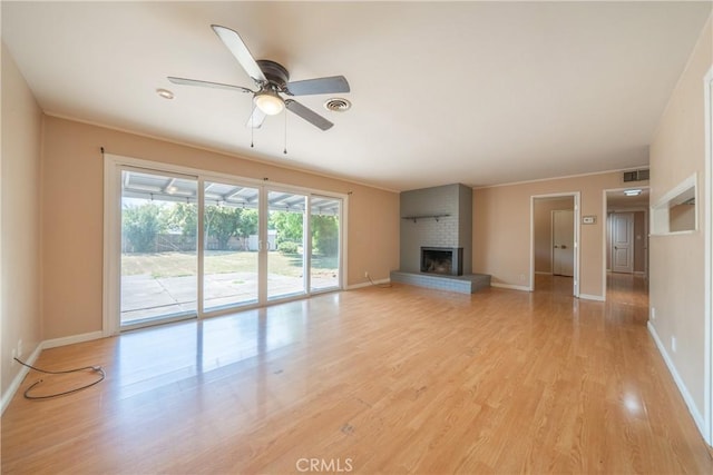 1577 Hawthorne Ave, Chico, CA 95926 - unfurnished living room featuring a ceiling fan, light wood-style floors, and a fireplace