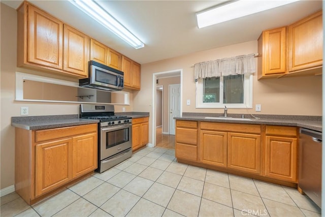1577 Hawthorne Ave, Chico, CA 95926 - kitchen with appliances with stainless steel finishes, dark countertops, and light tile patterned floors