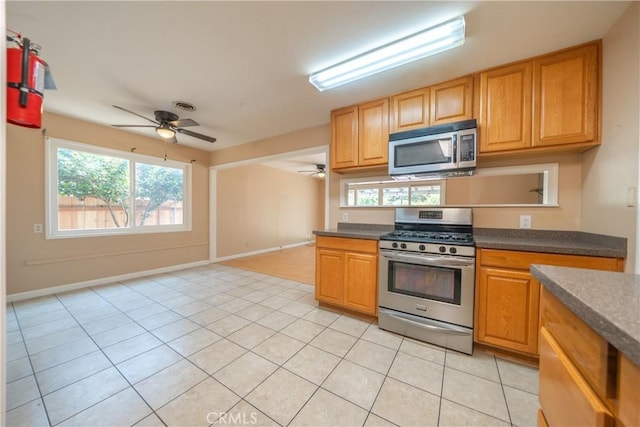 1577 Hawthorne Ave, Chico, CA 95926 - kitchen with appliances with stainless steel finishes, ceiling fan, dark countertops, and healthy amount of natural light