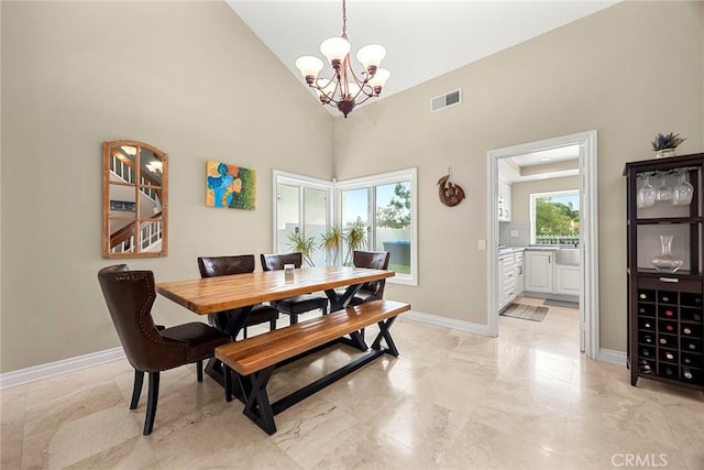 6 Sand Pointe, Laguna Niguel, CA 92677 - dining area featuring a chandelier, light marble finish flooring, and a high ceiling