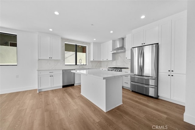 33851 Malaga Dr, Dana Point, CA 92629 - kitchen featuring appliances with stainless steel finishes, wall chimney range hood, light countertops, a kitchen island, and decorative backsplash