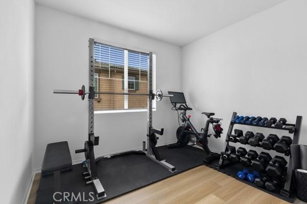 15940 Lasselle St Unit 1, Moreno Valley, CA 92551 - workout room featuring wood finished floors and baseboards