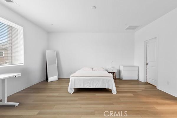 15940 Lasselle St Unit 1, Moreno Valley, CA 92551 - bedroom with light wood-type flooring and baseboards