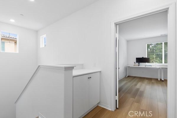 15940 Lasselle St Unit 1, Moreno Valley, CA 92551 - hall featuring an upstairs landing, a desk, light wood finished floors, and recessed lighting