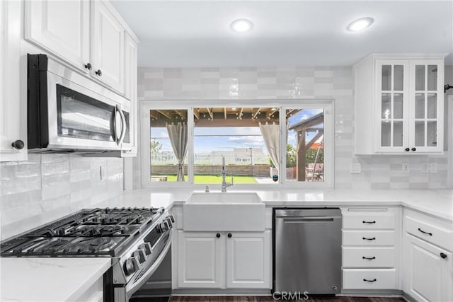 21751 Lanar, Mission Viejo, CA 92692 - kitchen with appliances with stainless steel finishes, white cabinetry, glass insert cabinets, tasteful backsplash, and recessed lighting