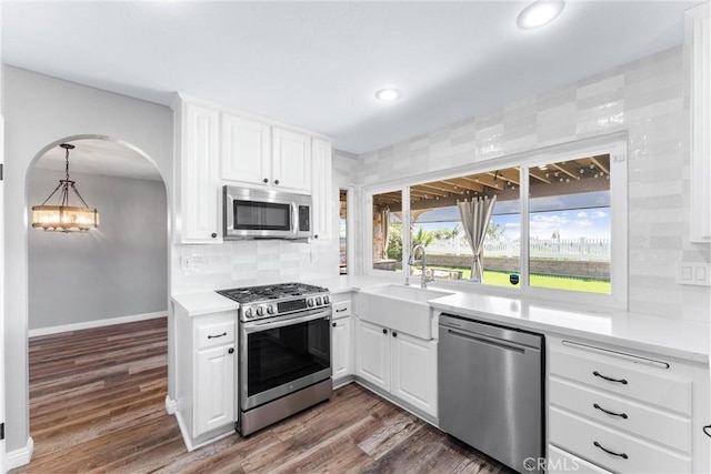 21751 Lanar, Mission Viejo, CA 92692 - kitchen with stainless steel appliances, a chandelier, light countertops, white cabinets, and dark wood finished floors