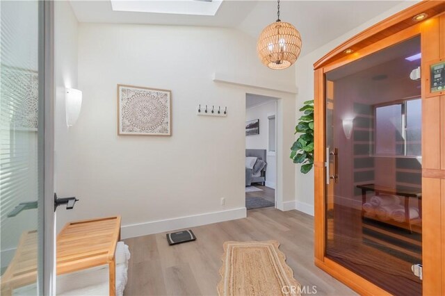 14757 Rockhill Dr, Hacienda Heights, CA 91745 - hall featuring a chandelier, a skylight, light wood-style floors, and lofted ceiling
