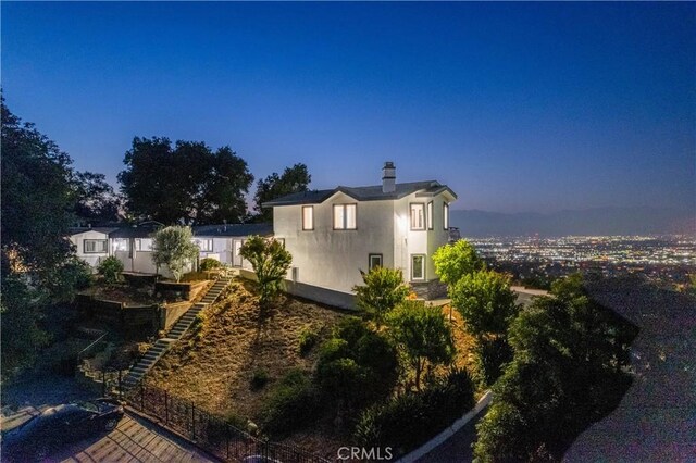 14757 Rockhill Dr, Hacienda Heights, CA 91745 - view of side of home featuring stairway, stucco siding, and a chimney