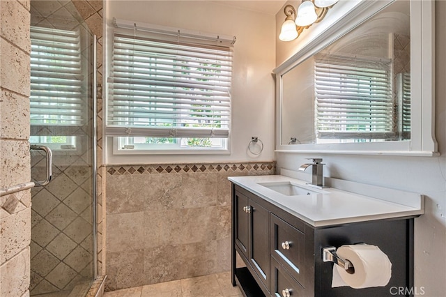 20129 Halsted St, Chatsworth, CA 91311 - bathroom featuring healthy amount of natural light, a stall shower, vanity, tile walls, and a wainscoted wall