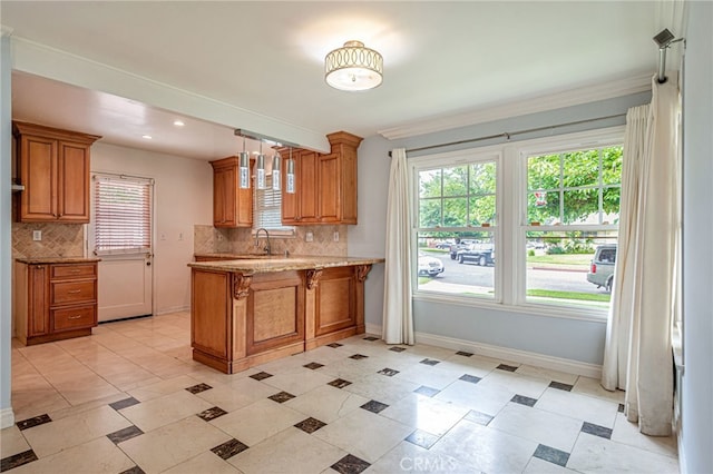 20129 Halsted St, Chatsworth, CA 91311 - kitchen featuring a peninsula, decorative backsplash, brown cabinets, plenty of natural light, and recessed lighting