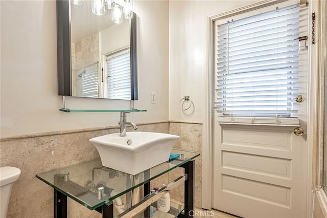 20129 Halsted St, Chatsworth, CA 91311 - bathroom featuring tile walls, a wainscoted wall, plenty of natural light, and a shower
