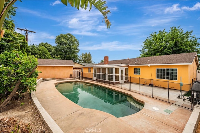 20129 Halsted St, Chatsworth, CA 91311 - view of swimming pool with a patio, a fenced backyard, and a sunroom