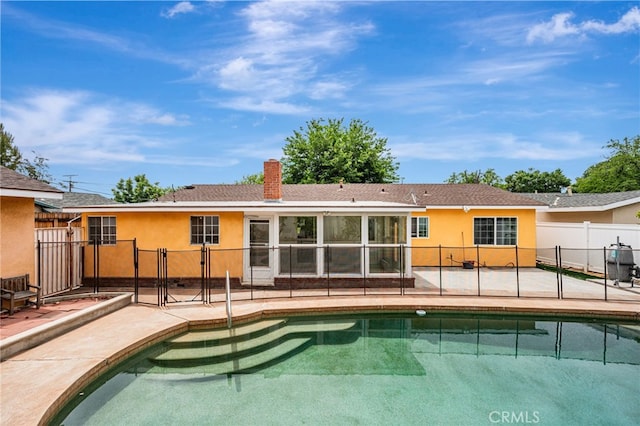 20129 Halsted St, Chatsworth, CA 91311 - rear view of house featuring a patio, stucco siding, and a chimney