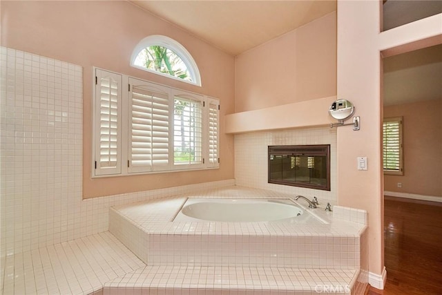 26821 Moore Oaks Rd, Laguna Hills, CA 92653 - bathroom with a bath, wood finished floors, and a fireplace