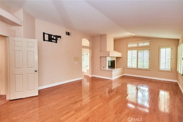 26821 Moore Oaks Rd, Laguna Hills, CA 92653 - unfurnished living room featuring light wood-style flooring, lofted ceiling, and a fireplace
