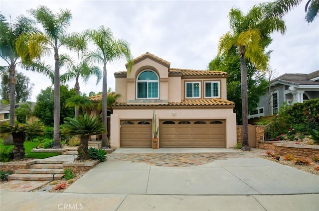 26821 Moore Oaks Rd, Laguna Hills, CA 92653 - mediterranean / spanish-style home featuring a garage, stucco siding, driveway, and a tile roof