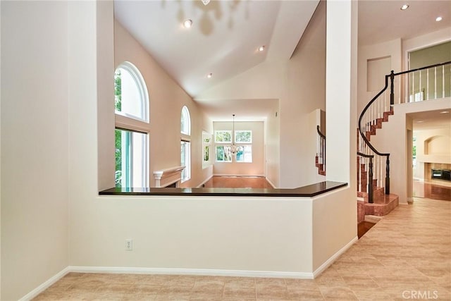 26821 Moore Oaks Rd, Laguna Hills, CA 92653 - kitchen with plenty of natural light, high vaulted ceiling, a fireplace, dark countertops, and recessed lighting