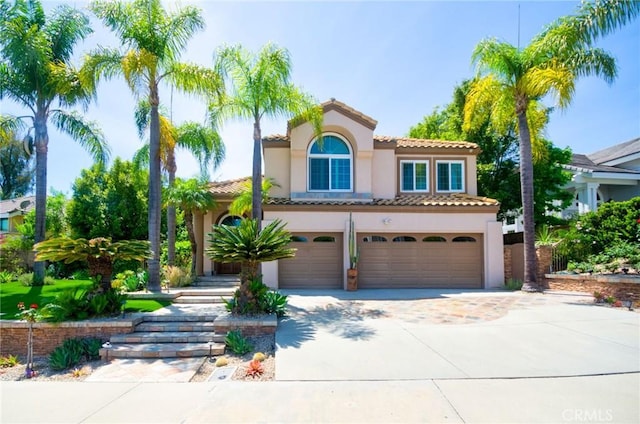 26821 Moore Oaks Rd, Laguna Hills, CA 92653 - mediterranean / spanish-style house featuring an attached garage, stucco siding, a tiled roof, and concrete driveway