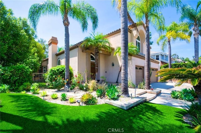26821 Moore Oaks Rd, Laguna Hills, CA 92653 - view of front facade featuring an attached garage, stucco siding, a front lawn, a chimney, and driveway