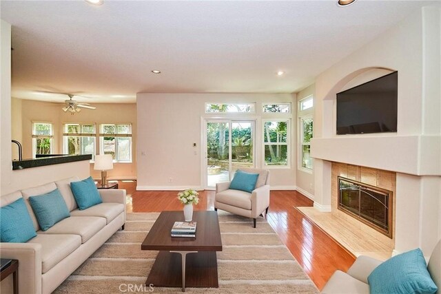 26821 Moore Oaks Rd, Laguna Hills, CA 92653 - living area with a tile fireplace, light wood-style flooring, recessed lighting, and a ceiling fan
