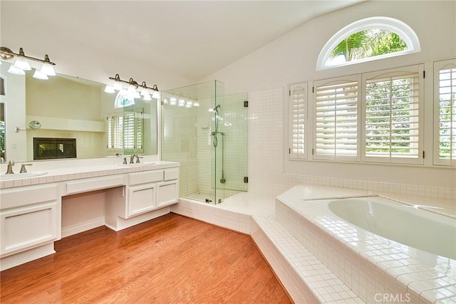 26821 Moore Oaks Rd, Laguna Hills, CA 92653 - bathroom featuring double vanity, a garden tub, vaulted ceiling, healthy amount of natural light, and a shower stall