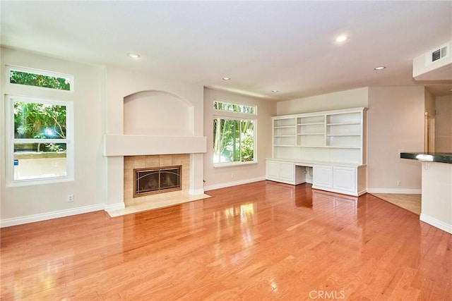 26821 Moore Oaks Rd, Laguna Hills, CA 92653 - unfurnished living room featuring a tile fireplace, recessed lighting, and light wood-type flooring