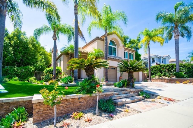 26821 Moore Oaks Rd, Laguna Hills, CA 92653 - mediterranean / spanish-style house with stucco siding, an attached garage, concrete driveway, and a tiled roof