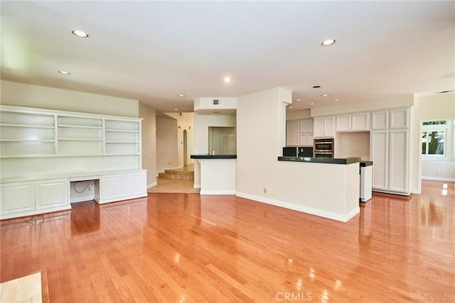 26821 Moore Oaks Rd, Laguna Hills, CA 92653 - unfurnished living room with light wood-style floors, recessed lighting, and an office area
