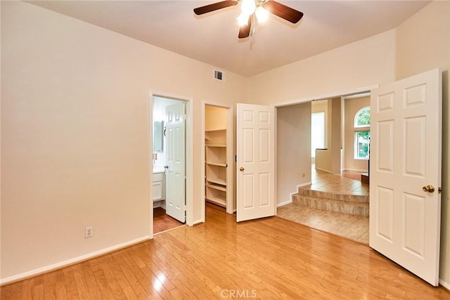 26821 Moore Oaks Rd, Laguna Hills, CA 92653 - unfurnished bedroom featuring light wood-style floors, a spacious closet, ensuite bath, and ceiling fan