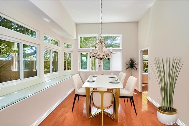 26821 Moore Oaks Rd, Laguna Hills, CA 92653 - dining space with healthy amount of natural light, wood finished floors, a chandelier, and a high ceiling