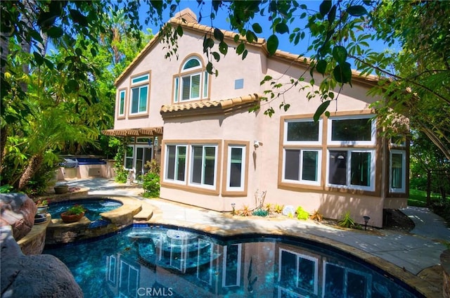 26821 Moore Oaks Rd, Laguna Hills, CA 92653 - back of house featuring stucco siding, a tiled roof, a patio, and a pool with connected hot tub