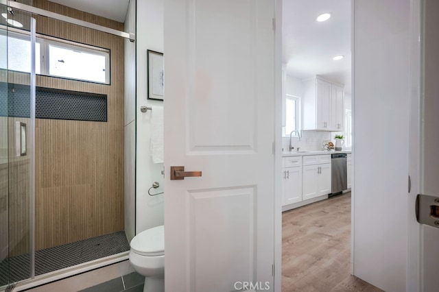 10028 Judy Ct, Riverside, CA 92503 - full bathroom featuring vanity, a shower stall, plenty of natural light, and wood finished floors