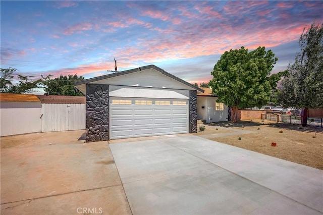 10028 Judy Ct, Riverside, CA 92503 - ranch-style home with driveway, stone siding, and a garage