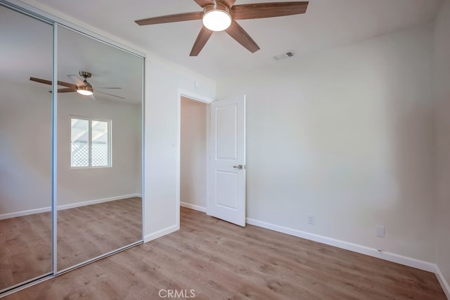 10028 Judy Ct, Riverside, CA 92503 - unfurnished bedroom featuring a closet, wood finished floors, and a ceiling fan