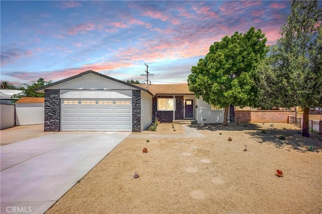 10028 Judy Ct, Riverside, CA 92503 - ranch-style house featuring concrete driveway, an attached garage, and stone siding