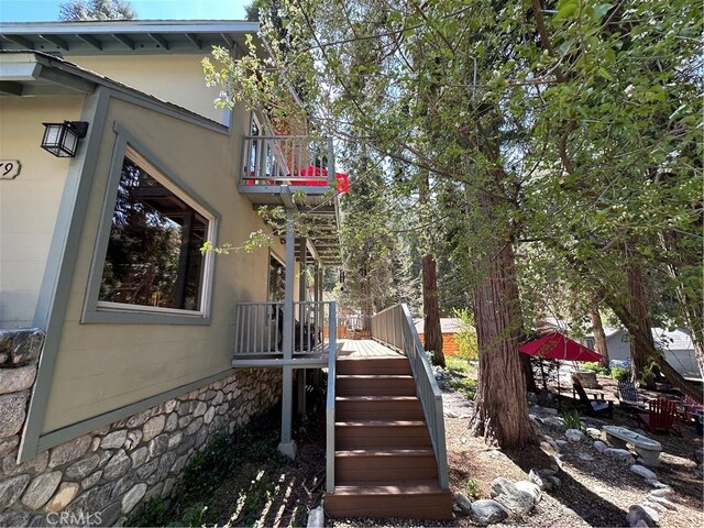 41379 Rainbow Ln, Forest Falls, CA 92339 - view of home's exterior featuring a wooden deck, stairway, stone siding, and a balcony