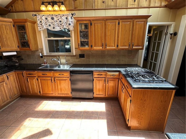 41379 Rainbow Ln, Forest Falls, CA 92339 - kitchen featuring dishwasher, brown cabinetry, decorative backsplash, a peninsula, and glass insert cabinets