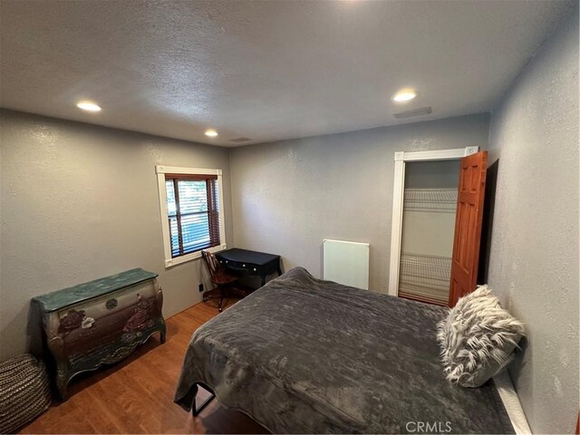 41379 Rainbow Ln, Forest Falls, CA 92339 - bedroom with wood finished floors, recessed lighting, and a textured wall
