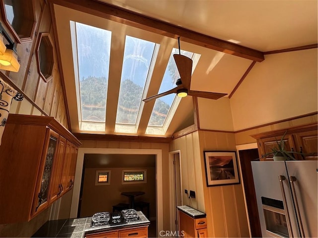41379 Rainbow Ln, Forest Falls, CA 92339 - detailed view of refrigerator with ice dispenser, ceiling fan, beamed ceiling, and a skylight