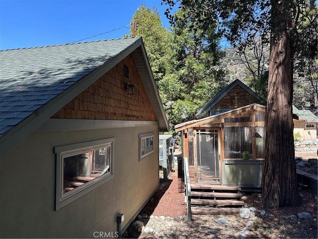 41379 Rainbow Ln, Forest Falls, CA 92339 - view of side of property with roof with shingles, stucco siding, and an outdoor structure