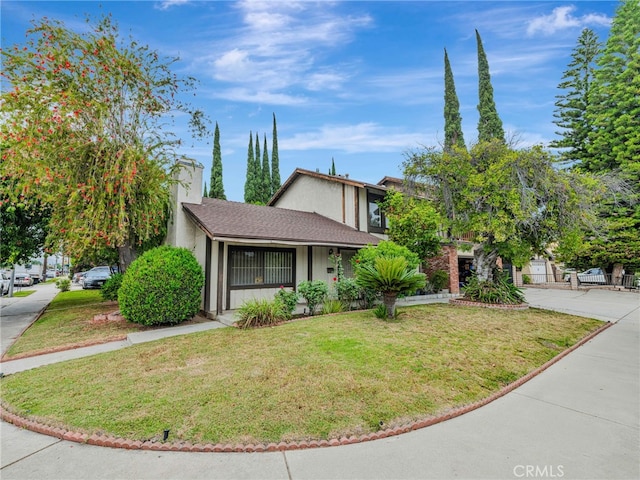 7800 Winnetka Ave, Winnetka, CA 91306 - view of front of home featuring stucco siding and a front lawn