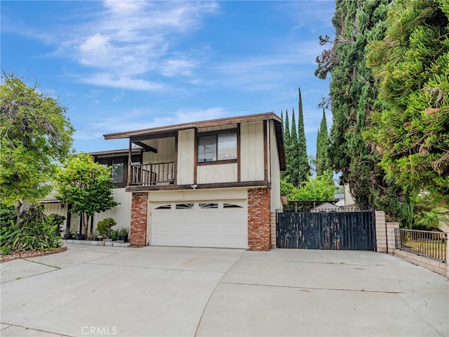 7800 Winnetka Ave, Winnetka, CA 91306 - view of front of house featuring concrete driveway, a balcony, a garage, and brick siding