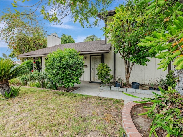 7800 Winnetka Ave, Winnetka, CA 91306 - view of front of house featuring a chimney and a front yard