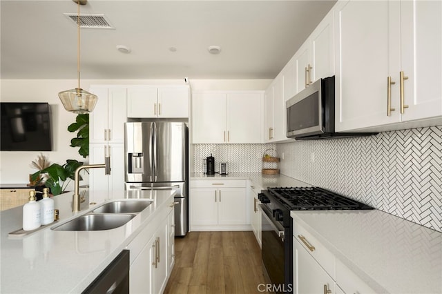 3540 E Peckham Paseo Unit 5, Ontario, CA 91761 - kitchen featuring stainless steel appliances, light countertops, backsplash, and white cabinets