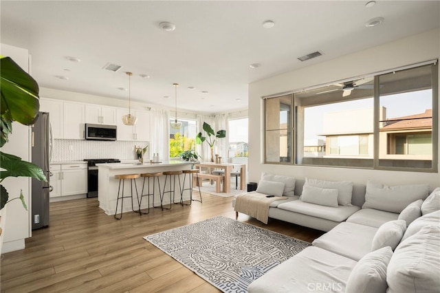3540 E Peckham Paseo Unit 5, Ontario, CA 91761 - living room with ceiling fan, light wood-style flooring, and recessed lighting