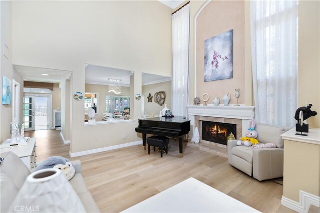 21620 Brisbane Way, Yorba Linda, CA 92887 - living area with wood finished floors, a fireplace, a towering ceiling, and ornamental molding