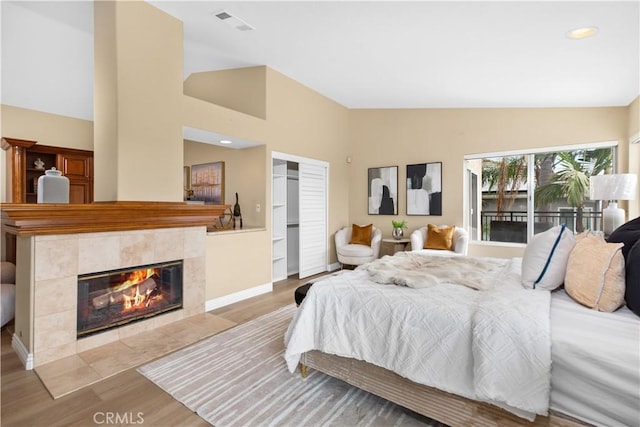 21620 Brisbane Way, Yorba Linda, CA 92887 - bedroom with wood finished floors, a tile fireplace, a closet, high vaulted ceiling, and recessed lighting