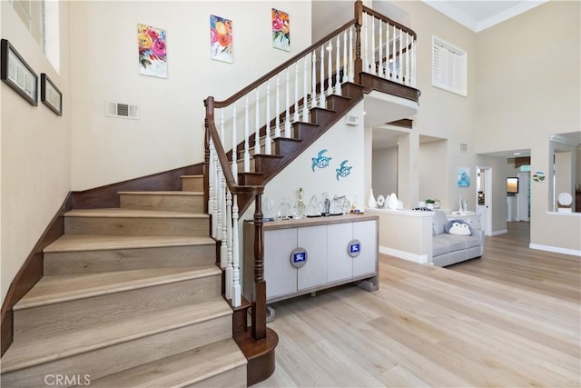 21620 Brisbane Way, Yorba Linda, CA 92887 - stairway with a towering ceiling, wood finished floors, and crown molding