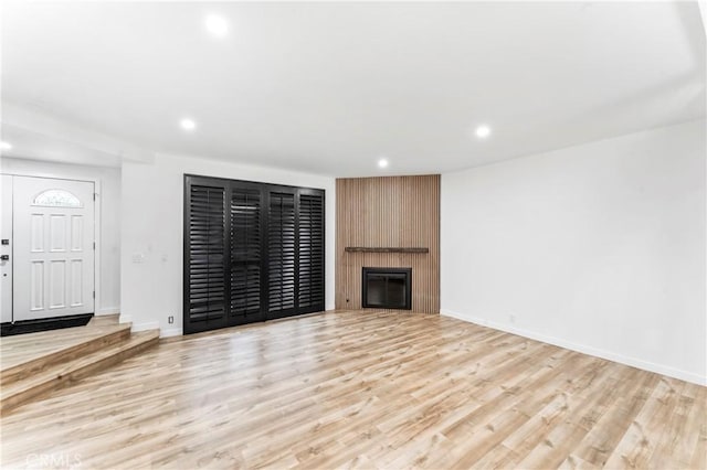 5401 Zelzah Ave Unit 114, Encino, CA 91316 - unfurnished living room featuring recessed lighting, light wood-style floors, and a large fireplace